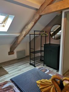a attic room with a bed and a mirror at Normandie, mer et campagne in Ver-sur-Mer