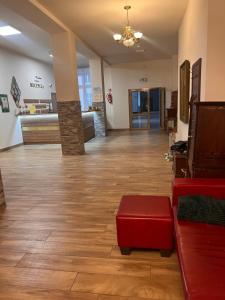 a lobby with a couch and a red stool in a room at Nauczycielskie Centrum in Zakopane