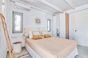 a bedroom with a large bed in a white room at Antiparos Thea in Antiparos