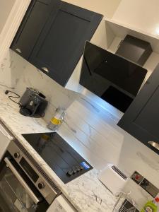 an overhead view of a kitchen with black cabinets at Station House in Batley