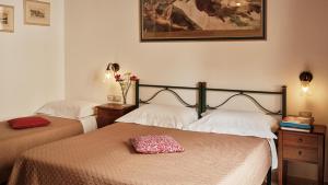 - une chambre avec 2 lits et une photo sur le mur dans l'établissement Cagliari Novecento, à Cagliari