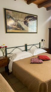 a bedroom with a bed and a picture on the wall at Cagliari Novecento in Cagliari