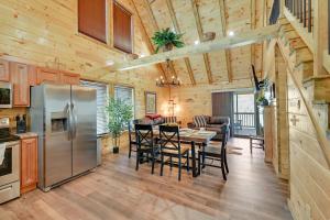 a kitchen and dining room with a stainless steel refrigerator at Riverside Beattyville Cabin with Kayaks and Fire Pit! in Beattyville
