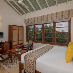 a bedroom with a large white bed and a table at Taavetti in Galle +102 photos