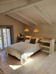 a bedroom with a large bed and two lights at Casa con encanto en Laxe in Laxe