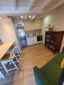 a living room with a table and a kitchen at Casa con encanto en Laxe in Laxe