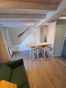 a dining room with a table and chairs in a room at Casa con encanto en Laxe in Laxe