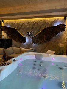 a bath tub with wings on the wall at Little House in Ząb