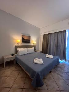 Postel nebo postele na pokoji v ubytování Aristea Hotel