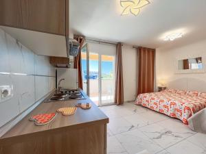 a kitchen with a sink and a bed in a room at Zeus in Bibione