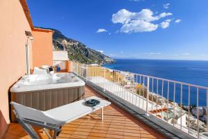 a balcony with a view of the ocean at BlueVista Dreamscape Home -Terrace Jacuzzi/Hot Tub in Positano