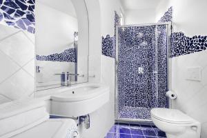 a bathroom with a toilet sink and a shower at BlueVista Dreamscape Home -Terrace Jacuzzi/Hot Tub in Positano +16 photos