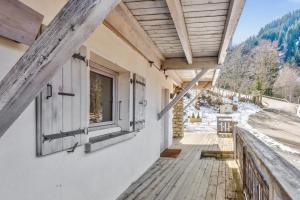 a balcony of a house with a window at Exceptional flat in a chalet - Megève - Welkeys in Megève