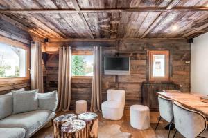 a living room with a couch and a table at Exceptional flat in a chalet - Megève - Welkeys in Megève