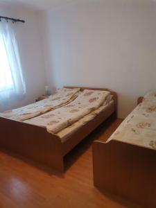 a bedroom with two beds and a window at Smestaj Vlasina in Surdulica