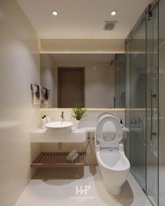 a bathroom with a toilet and a sink and a shower at Mai An Hotel in Móng Cái