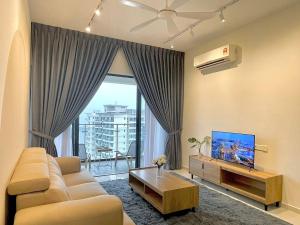 a living room with a couch and a large window at Country Garden by Antlerzone in Johor Bahru
