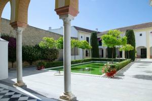 a courtyard with a fountain in the middle of a building at Duplex near MEZQUITA of Córdoba & Free Private Parking in Córdoba