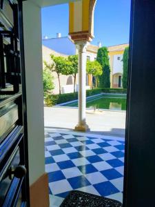 a view of a checkered floor from an open door at Duplex near MEZQUITA of Córdoba & Free Private Parking in Córdoba