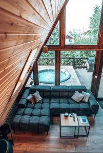 a living room with a couch and a swimming pool at Valdo Cabin in Sadu