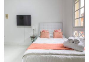 a bedroom with a large bed with towels on it at Lovely studio at the city heart! in Málaga