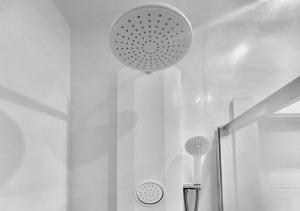 a bathroom with a shower with a light hanging from the ceiling at Lovely studio at the city heart! in Málaga