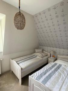 two beds in a bedroom with a wall with planes at Haus-Seeschwalbe-Wohnung-2 in Nieblum