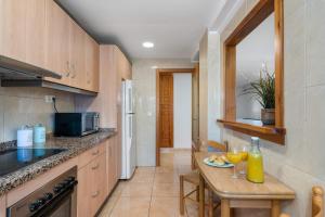 a kitchen with a table with a plate of food on it at Villa Caleta - PlusHolidays in Calpe