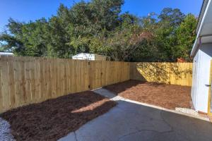 a wooden fence in front of a yard at Cathy and Jim's Florida Beach House in Fort Walton Beach