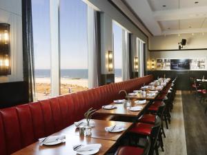 a row of tables in a restaurant with a view of the ocean at Bally's Atlantic City Hotel & Casino in Atlantic City