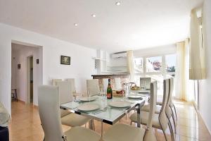 a dining room with a glass table and chairs at Villa Calalga - PlusHolidays in Calpe