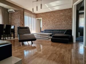 a living room with a couch and a table at SkopjeLUX Apartments in Skopje