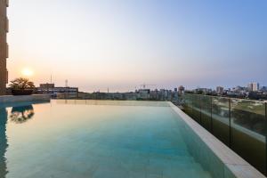 a swimming pool on the roof of a building at Hotel Alvalade in Luanda