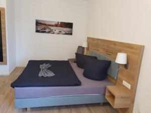 a small bedroom with a bed with a purple mattress at Porse Appartements in Magdeburg