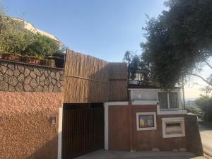 a building with a fence next to a wall at Soggiorno baciato dal sole in Forio d'Ischia