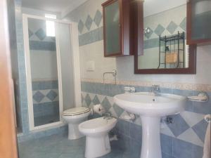 a bathroom with a sink and a toilet at Soggiorno baciato dal sole in Forio d'Ischia +6 photos