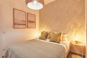 A bed or beds in a room at Soho Apartments in Malaga by Solaga Holiday Homes