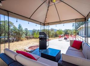a large tent with two couches and a grill at Cherry Cottage 15 min from Yosemite South Entrance in Oakhurst