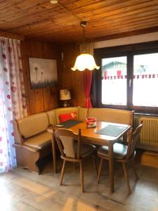 een eetkamer met een tafel en een bank bij Ferienwohnung Pusteblume in Alpirsbach