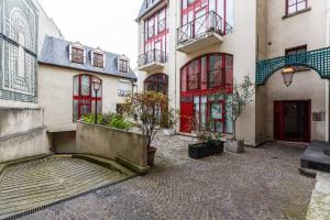 a group of buildings with red doors and windows at Paris Studio @Arc de Triomphe in Paris