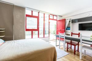 a bedroom with a bed and a desk and window at Paris Studio @Arc de Triomphe in Paris