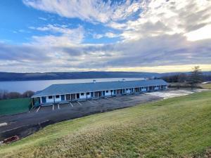 an aerial view of a large building next to a lake at The Hotel Laurel at Seneca in Watkins Glen