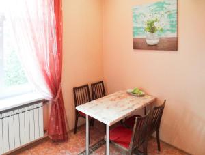 a table and chairs in a room with a window at Apartment on Independence Square in Kyiv