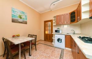 a kitchen with a table and a washing machine at Apartment on Independence Square in Kyiv