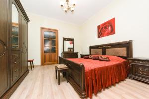 a bedroom with a large bed with a red blanket at Apartment on Independence Square in Kyiv
