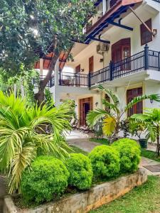 a house with a garden in front of it at Marathona Tourist Resort - Anuradhapura in Anuradhapura