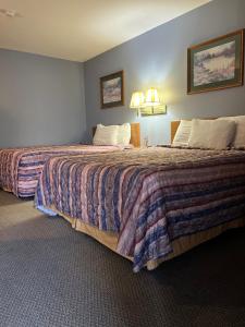 a hotel room with two beds and two lamps at Best Budget Inn Owatonna in Owatonna