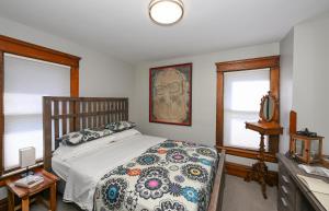 a bedroom with a bed and two windows at Berrodin Bed & Breakfast in Akron