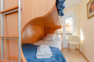 a bedroom with a bunk bed and a spiral staircase at Serendipity by Fidalsa in Teruel