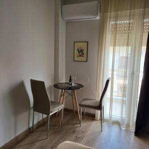 a dining room with a table and chairs and a window at COSY APARTMENT IN VERIA in Veria